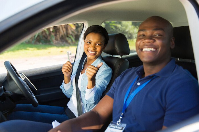 young black woman passing a drivers test with a black driving instructor representing the best african american affiliate programs