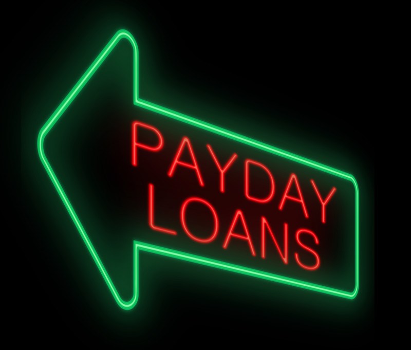  A green neon sign in the shape of an arrow contains the words 'payday loans' in red, representing the best payday loan affiliate programs.