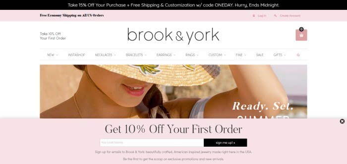 This screenshot for the home page of Brook & York shows a close-up photo of a young woman wearing a straw hat and some Brook & York jewelry. 