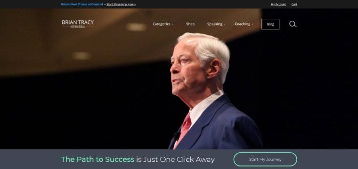 This screenshot of the home page for Brian Tracy shows a photo of Brian Tracy from the side, while he appears to be speaking to a large group of people. 