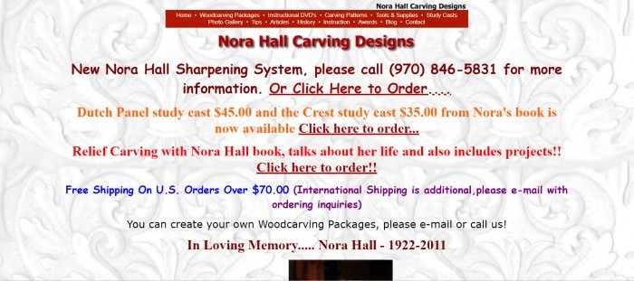 This screenshot of the Nora Hall Carving Designs home page shows an intricate relief carving as a background with several lines of text in yellow, red, blue, and black across it, with the words "Nora Hall Carving Designs" in red lettering at the top of the page.