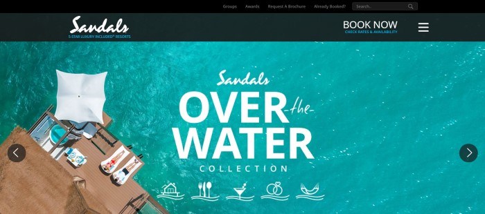 This screenshot of the home page for Sandals shows an overhead shot of beach patio, where two people sun themselves on lounge chairs next to an aqua-colored ocean.