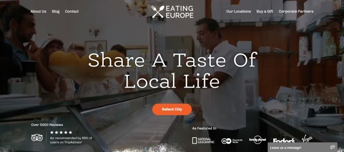 This screenshot of the home page for Eating Europe shows a dark-filtered photo of a food case and people preparing to taste food, with the words "Share a Taste of Local Life" in white lettering across it.