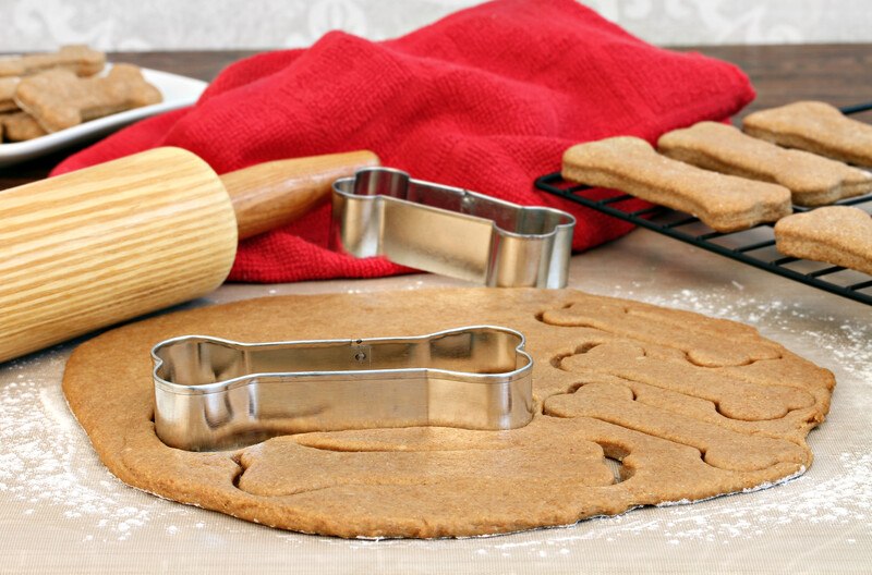 cookie cutter in the shape of a dog bone and some home made (probably) dog treats