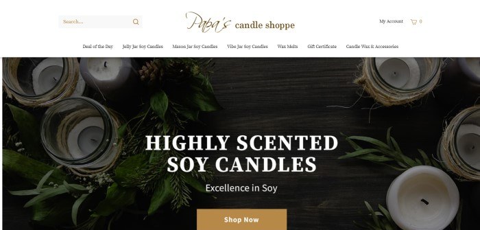 This screenshot of the home page for Papa's Candle Shoppe shows an overhead view of white soy candles among evergreen bows, behind white lettering that reads 