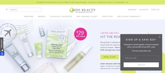 This screenshot of the home page for Juice Beauty shows several Juice Beauty products lying on a white envelope with a TSA approval stamp in the upper left corner and text in black and pink on the right side of the page announcing mini travel-packs, along with a pale green call-to-action button and a charcoal opt-in box for email updates. 