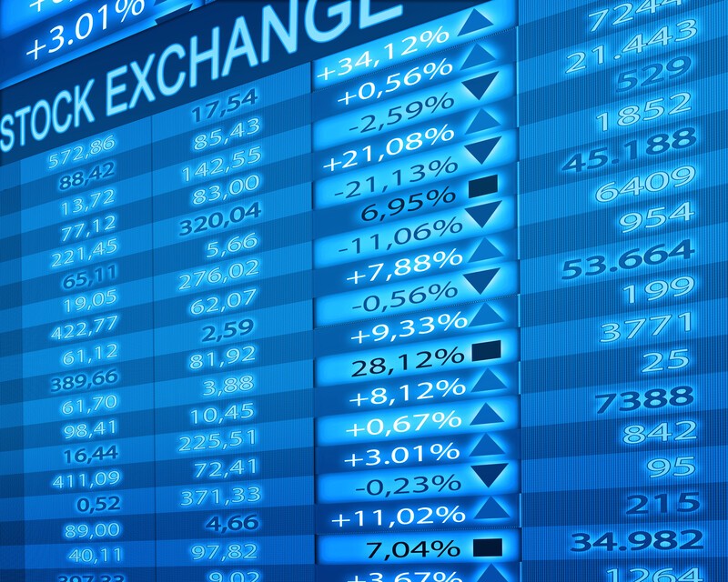 This photo shows a screen, in different shades of blue, that's filled with stock exchange information, representing the best stock trading affiliate programs.