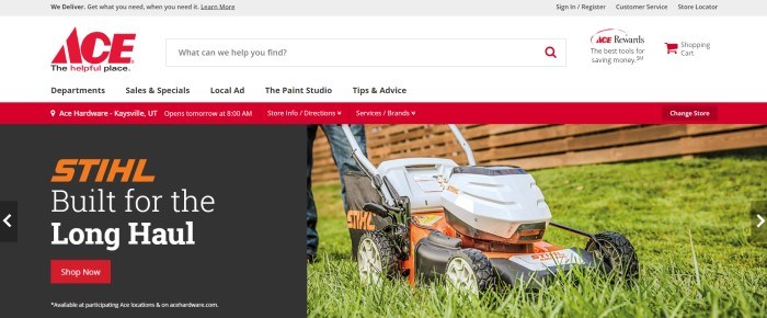 This screenshot of the home page for Ace Hardware has a red information bar below a white navigation bar and above a photo of a Stihl lawn mower on green grass, next to a section with a black background orange and white text, and a red call-to-action button for shopping for Stihl products.