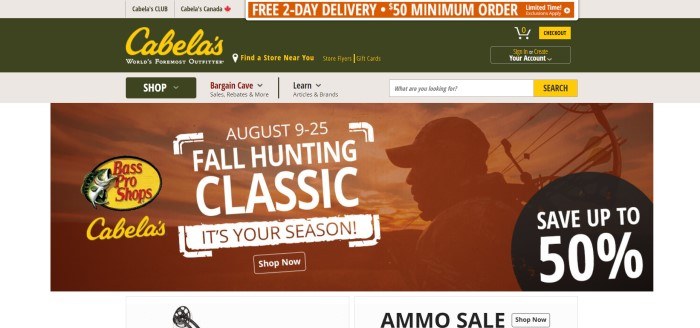 This screenshot of the home page for Cabela's shows a dark green header with gold and green text above an orange-filtered photo of a bow hunter, near an advertisement in white text announcing a fall hunting classic and an ammo sale.