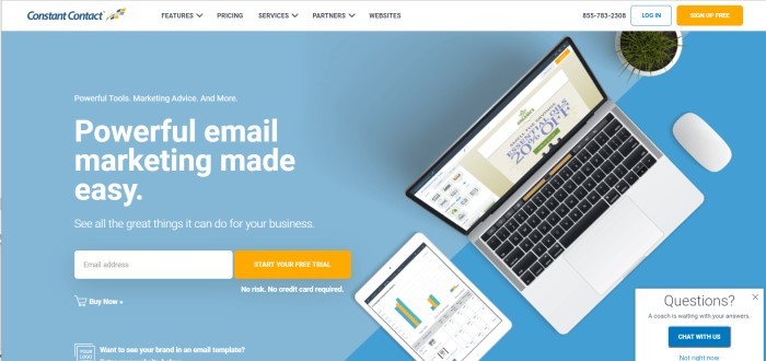  This screenshot of the home page for Constant Contact has a light blue background, a white header, and a photo of an open laptop next to a tablet that's displaying a bar graph.