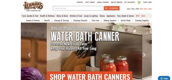 This screenshot of the home page for Lehman's has a white background with a large photo of a water bath canner, three bottles of canned tomatoes, and a set of knives, behind white text announcing an Amish-made stovetop water bath canner.