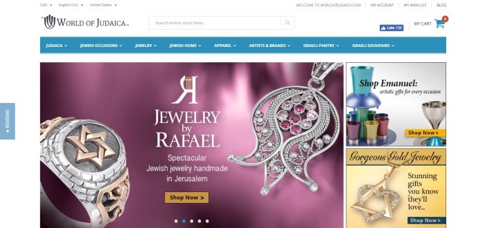 This screenshot of the home page for World of Judaica has a white background, a blue header, and a photo of silver and gold jewelry in front of a purple background.