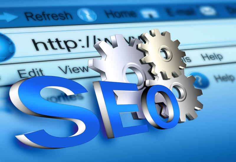 The letters SEO in blue and a set of three metal gears are laid over a computer screen with an open internet search bar with a slight blue tint, representing the best SEO affiliate programs. 