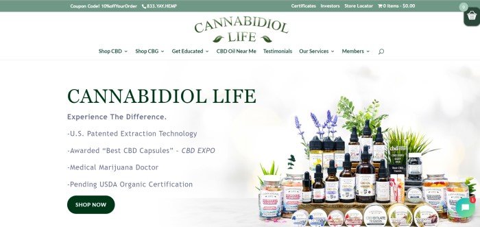 This screenshot of the home page for Cannabidiol Life has several marijuana edibles and other products lined up on a rustic table in front of green plants and purple flowers, near text in black lettering that tells more about company.