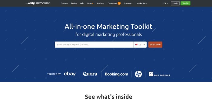 This screenshot of the home page for SEMrush shows a dark blue background with white circles and diagonal slashes behind white text announcing SEMrush as an all-in-one marketing toolkit and a rust-colored 'Start now' call-to-action button.