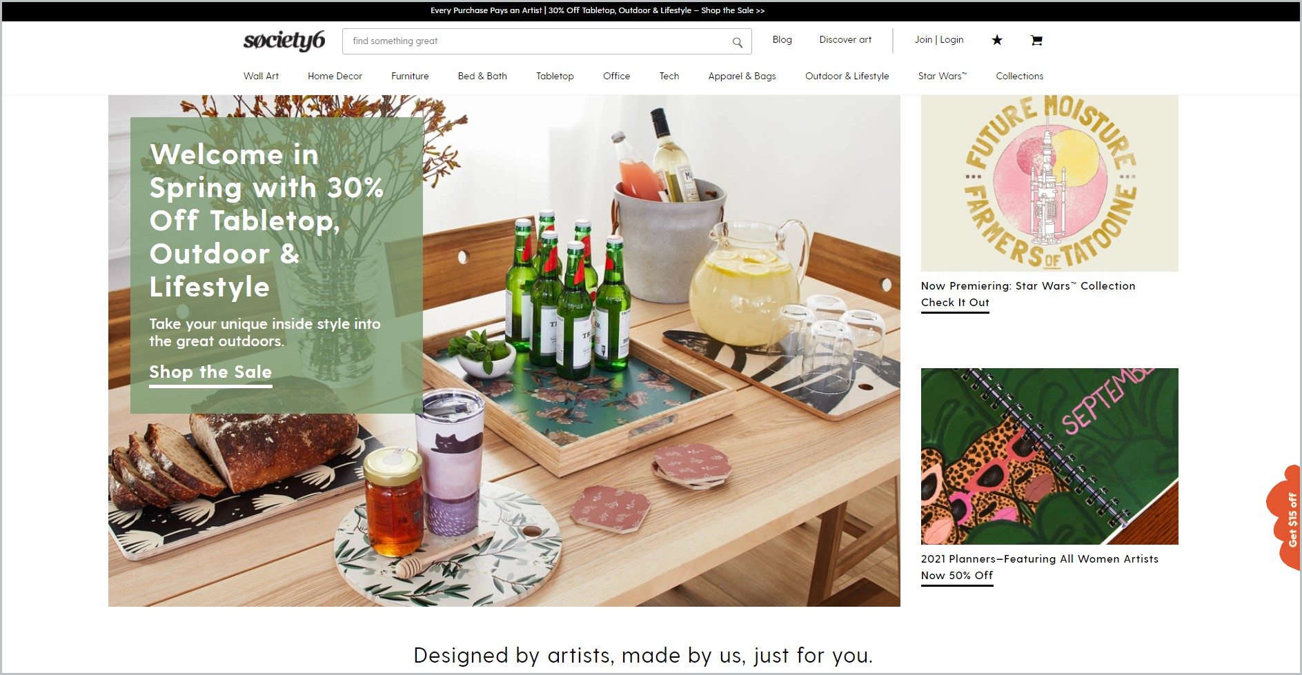 screenshot of Society6 homepage with dark grey announcement bar, white header bearing the website's name and main navigation menu, showcasing some of their products