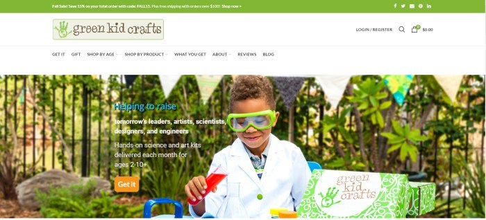  This screenshot for the home page for Green Kid Crafts shows boy in safety goggles and a white lab coat playing with a chemistry kit in front of a background of green growing plants and a banner made from multi-colored triangular-shaped pieces of fabric or paper.