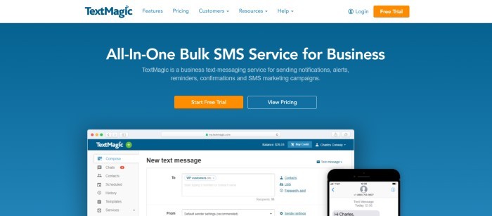 This screenshot of the home page for TextMagic has a white navigation bar above a plain blue section with white text announcing TextMagic as an all-in-one bulk SMS service for business, along with an orange call-to-action button and an image of TextMagic software open on laptop and a mobile device.