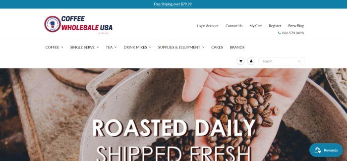 This screenshot of the home page for Coffee Wholesale USA has a white background with a closeup photo of a hand holding coffee beans, apparently dropping them into a metal bowl, behind white text which reads "Roasted daily, shipped fresh."