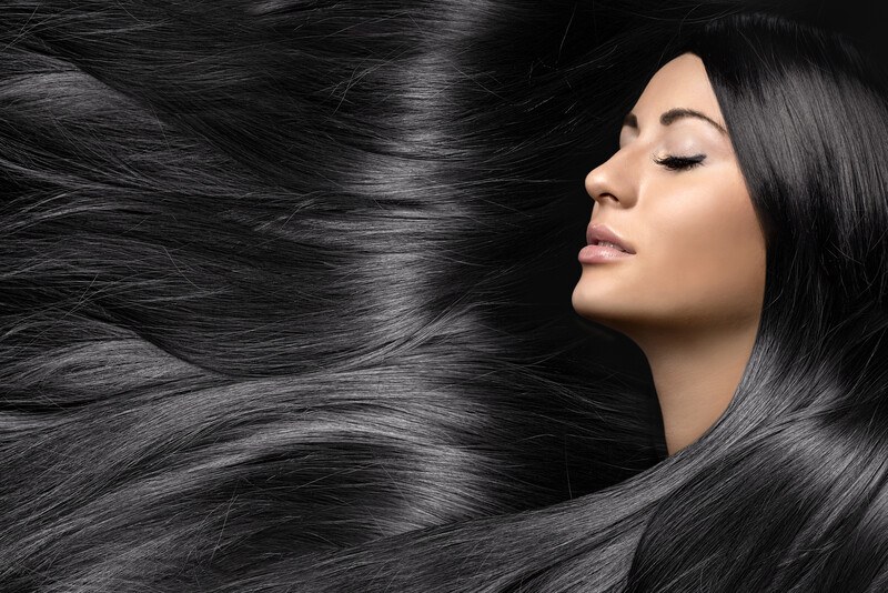 Best Hair Care Affiliate Programs | One More Cup of Coffee This photo shows a woman with closed eyes, whose dark hair flows through the entire photo, representing the best hair care affiliate programs.