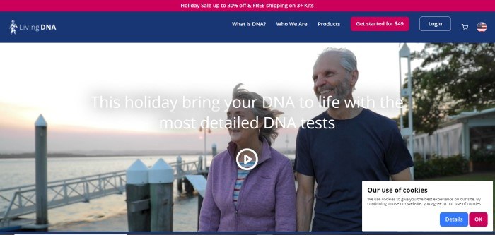 This screenshot of the home page for Living DNA has a red header announcing a holiday sale, a blue navigation bar with a red call to action button, and a large photo of an aging couple walking together along a lake's edge, smiling.