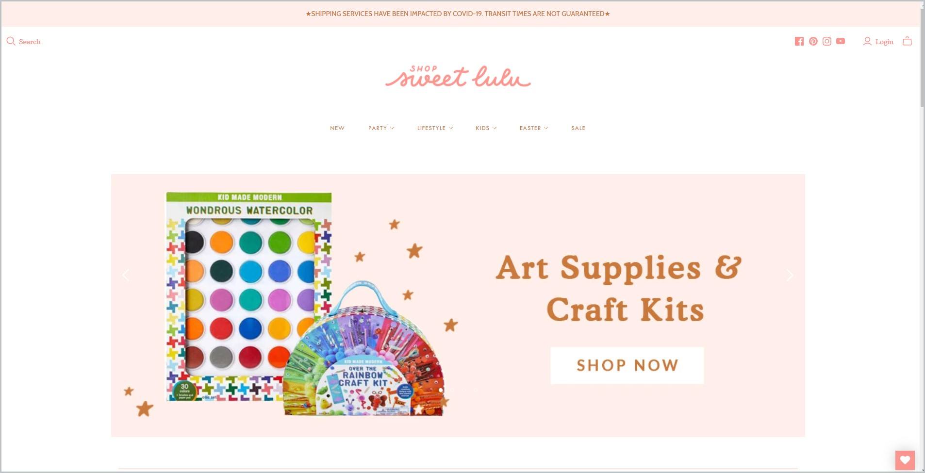 screenshot of Shop Sweet Lulu homepage with pale pink announcement bar, white header with the website's name and main navigation bar, it also showcases a picture of art supplies as main image