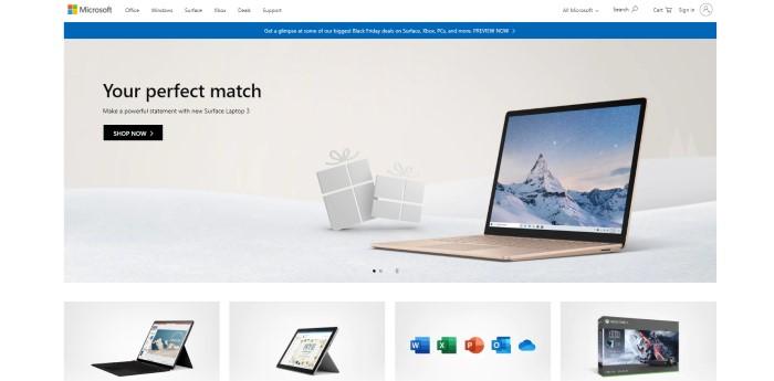 This screenshot of the home page for Microsoft has a white background and navigation bar above a blue announcement for previewing Black Friday deals and an image of an open Surface laptop on what appears to be snowy ground beneath a gray sky, with black words reading "Your perfect match" and a black call-to-action button. 