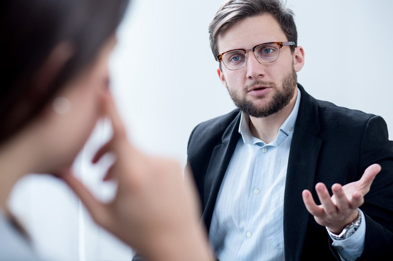 A professional man giving advice to a woman