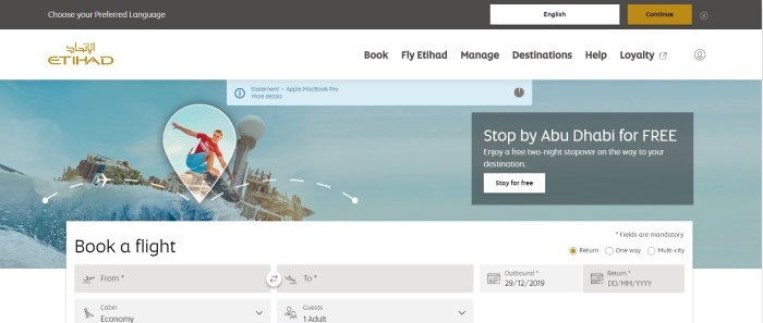 This screenshot of the home page for Etihad Airways has a black header with a window for choosing a preferred language, a white navigation bar, and a photo of a young man in a red shirt and blue shorts waterboarding with a waterpark in the background, along with an invitation to stop by Abu Dhabi and a large search window for booking a flight.