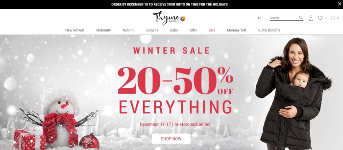 This screenshot of the home page for Thyme Maternity has a black header, a white navigation bar, and a photo of a smiling brown-haired woman with a baby, both wrapped inside a brown coat, standing near a snowman with a red scarf and surrounded by presents and ornaments, along with a winter sale announcement in red text. 