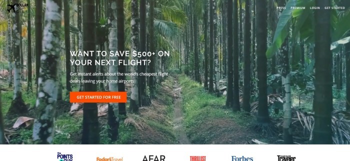 This screenshot of the home page for Dollar Flight Club shows a large photo of a trail in a jungle forest, along with white lettering reading "Want t save $500+ on your next flight?" and a red call-to-action button.