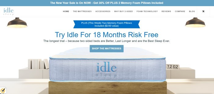 This screenshot of the home page for Idle Sleep has a light blue sales header, a white navigation bar, and a white-background photo of an Idle mattress on a brown base, along with blue text announcing the ability for customers to try these mattresses risk-free for 18 months.