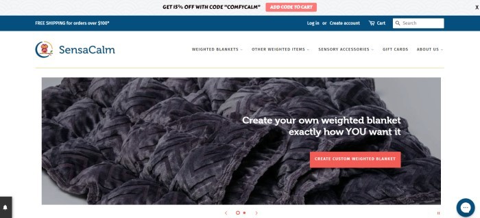 This screenshot of the home page for SensaCalm has a header of light gray and dark blue, a white navigation bar, and a dark filtered photo of a gray weighted blanket, along with white text inviting customers to create their own weighted blankets and a red call-to-action button. 