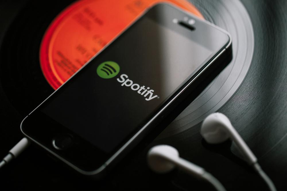 spotify app on smartphone with headphones