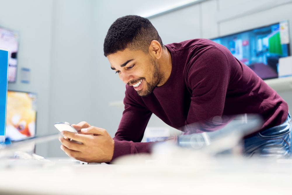 A happy man using his cellphone