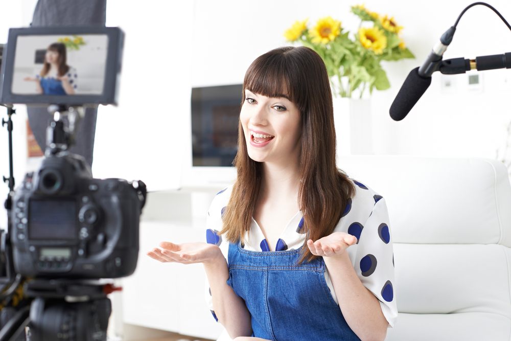 A woman standing in front of a camera