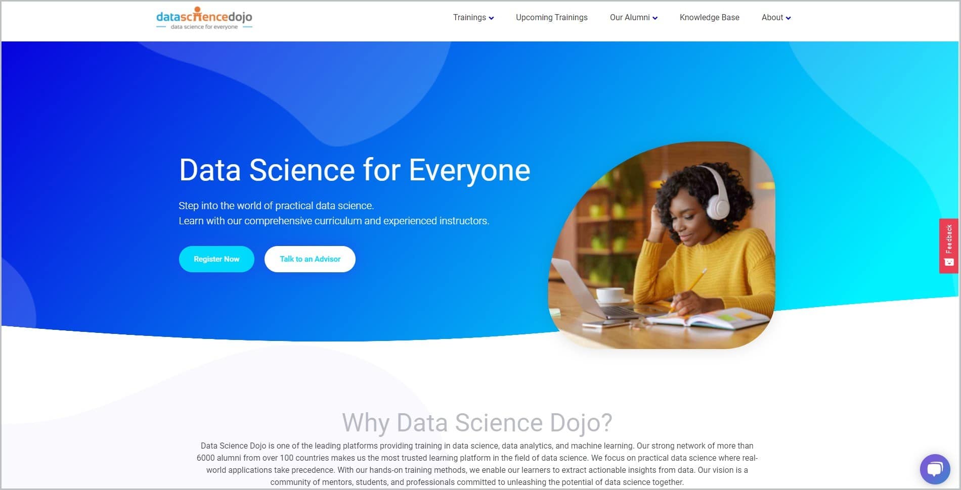 screenshot of Data Science Dojo homepage, with white header with the website's name and main navigation menu, it features an image of a black woman in mustard-colored top and white headset, seated on a table with her pen, notebook, laptop, and white cup and saucer