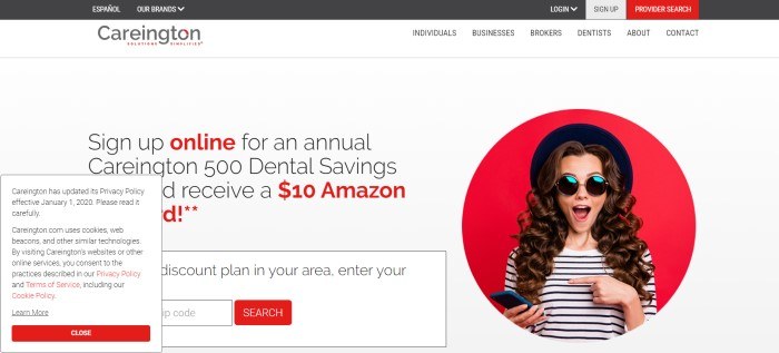 This screenshot of the home page for Careington has a black header, a white navigation bar, and a main section with a white background, a photo with a red background and a happy-looking brunette woman with a black hat and a black-and white striped shirt, and black and red text inviting customers to sign up for a dental savings plan.