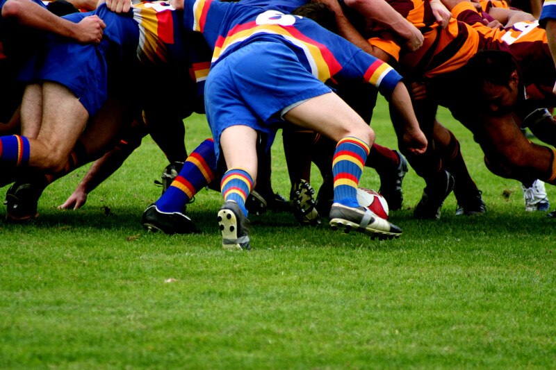 rugby scrum with blue and orange teams