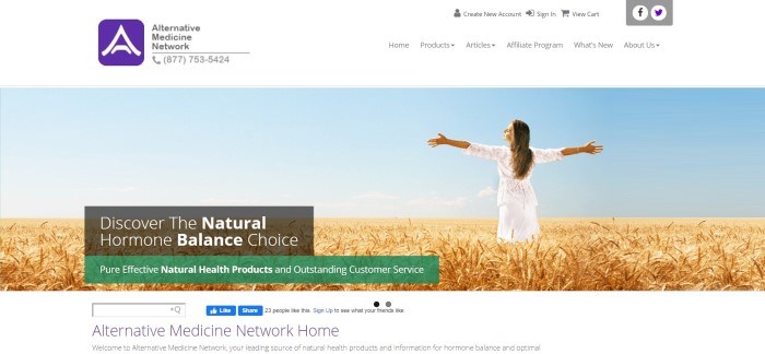 This screenshot of the home page for Alternative Medicine Network has a white header and navigation bar above a photo of a woman in a white dress, standing in a wheat field with her eyes closed and her face turned upward toward a blue sky, along with a small charcoal and green window announcing natural hormone balance options.