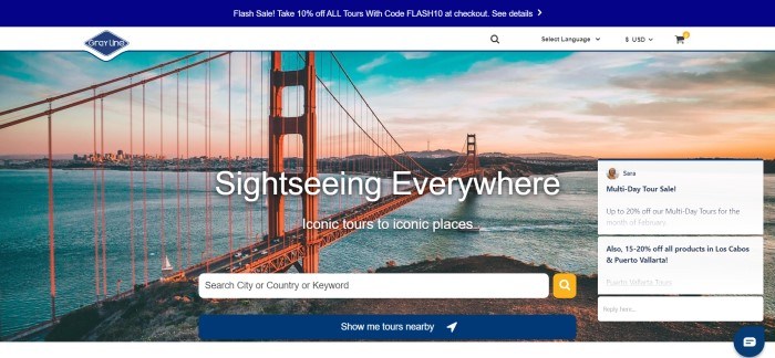 This screenshot of the home page for Gray Line has a dark blue header announcing a flash sale, a white navigation bar, and a photo of the Golden Gate Bridge at sunset, behind white text announcing sightseeing everywhere and a white search bar.