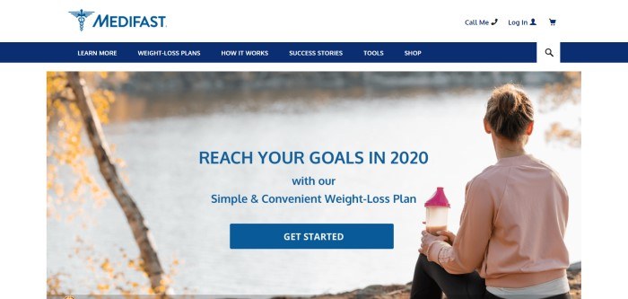 This screenshot of the home page for Medifast has a white header, a blue navigation bar, and a photo of a woman sitting near a lake holding a shaker bottle with brown liquid in it, along with blue text inviting people to reach their weight loss goals and a blue call to action button.