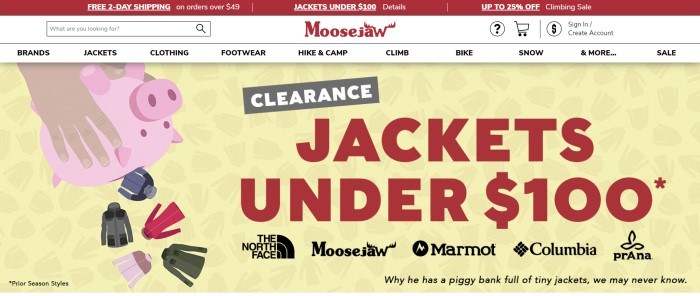 This screenshot of the home page for Moosejaw has a red header announcing free shipping and sales, a white navigation bar with a search bar, and a graphic with a yellow background and hands shaking a pink piggy-bank upside down while multicolored jackets fall out of it, next to red text announcing a jacket clearance sale.