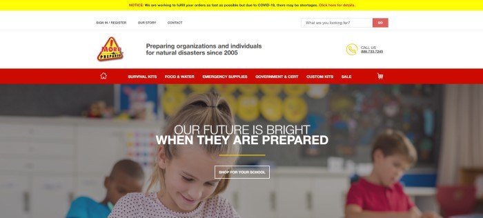 This screenshot of the home page for More Prepared has a yellow header announcing coronavirus shortages, a white search bar, a red navigation bar with white lettering, and a of a smiling blonde girl in a ponytail sitting in a classroom with her schoolmates, behind white lettering inviting schools to be prepared for disasters.