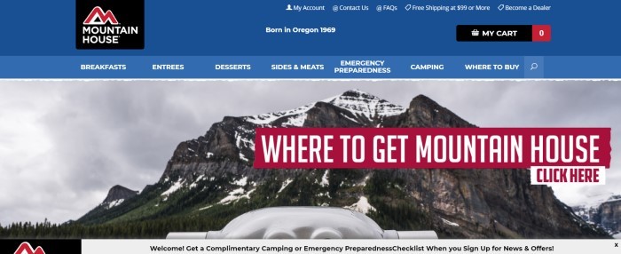 This screenshot of the home page of Mountain House has a blue header and navigation bar above a photo of a craggy mountain under a gray sky, along with a red banner with white text inviting customers to discover where to get Mountain House products.