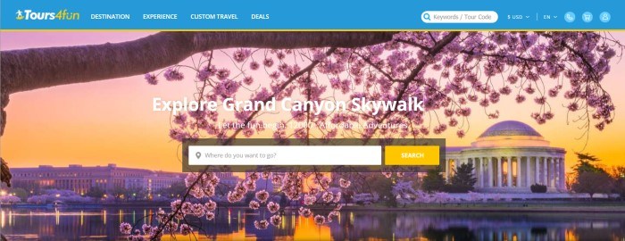 This screenshot of the home page for Tours4Fun has a blue, yellow, and white navigation bar above a large photo of a flowering tree and cityscape at sunset, along with white text inviting people to explore the Grand Canyon Skywalk and a white and yellow search bar.