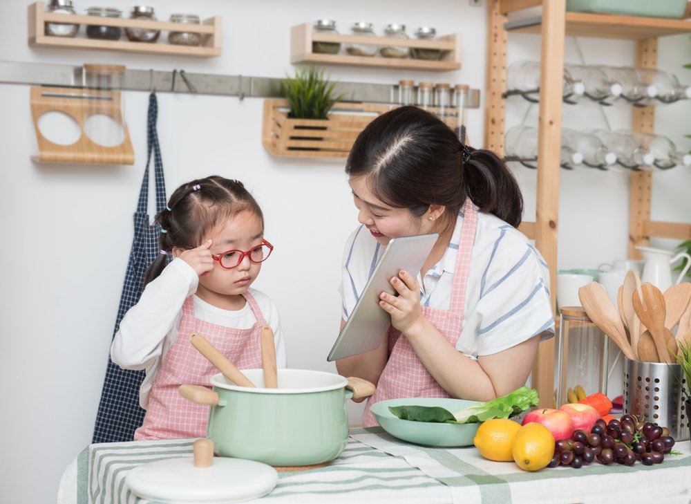 asian mom teaching child to cook for her food-focused mommy blog