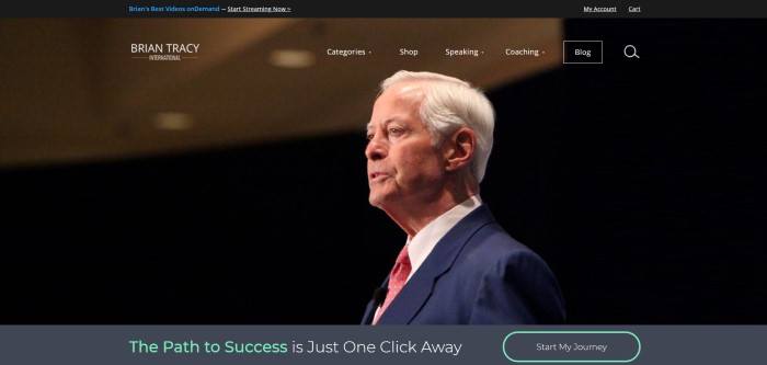 This screenshot of the home page for Brian Tracy has a black header above a transparent navigation bar and a large photo of white-haired man in a business suit, above a gray bar with green and white text inviting customers to start on the path to success and a call to action button.