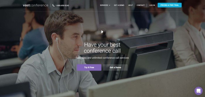 This screenshot of the home page for Vast Conference has a transparent navigation bar with white text and a blue call to action button overlaying a photo of a man with earbuds looking at a computer screen, behind white text announcing video conferencing and a purple call to action button.