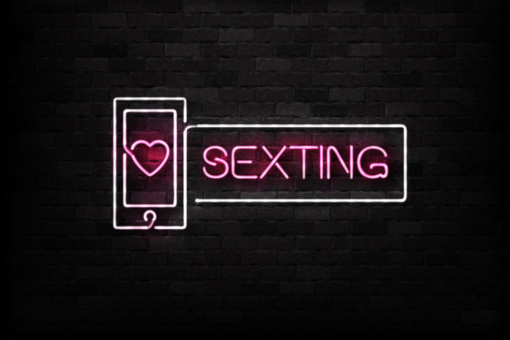 sexting sign in neon with pink text and white outline